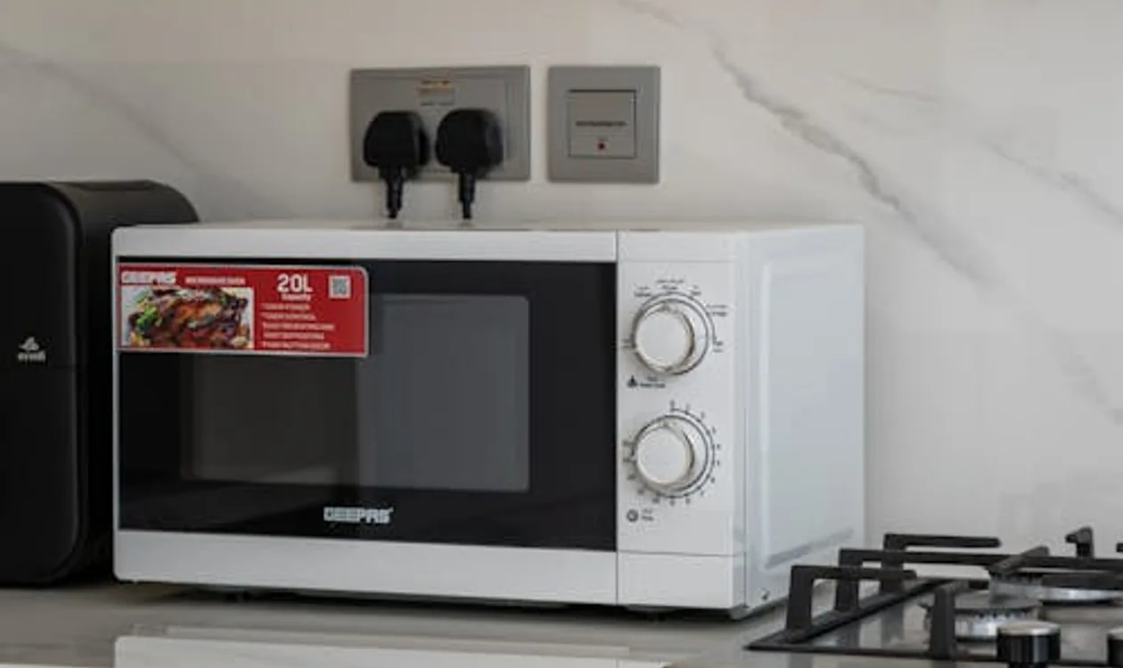 Over-the-range microwave installed above a kitchen stove in modern kitchen