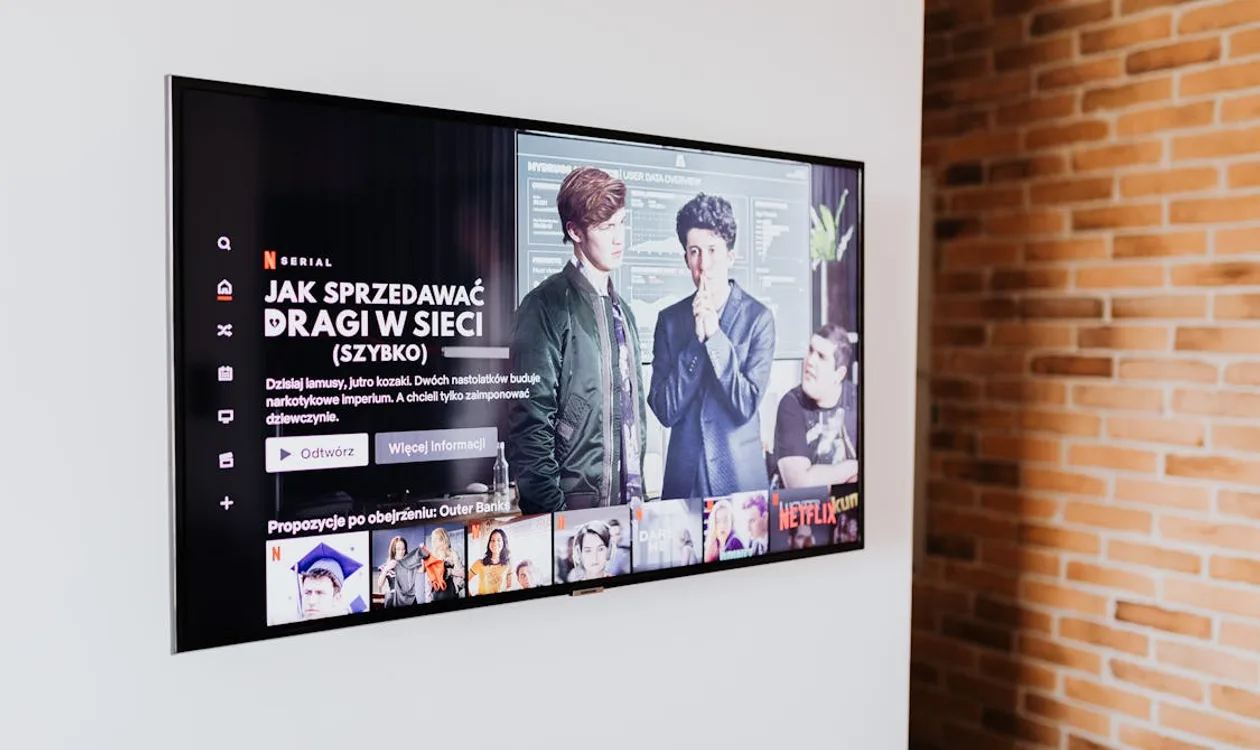 Modern living room with a large smart TV mounted on the wall above a media console