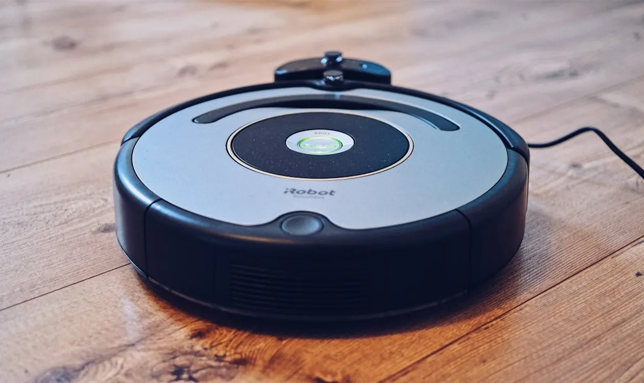 Robot vacuum cleaning a modern hardwood floor in a bright living room