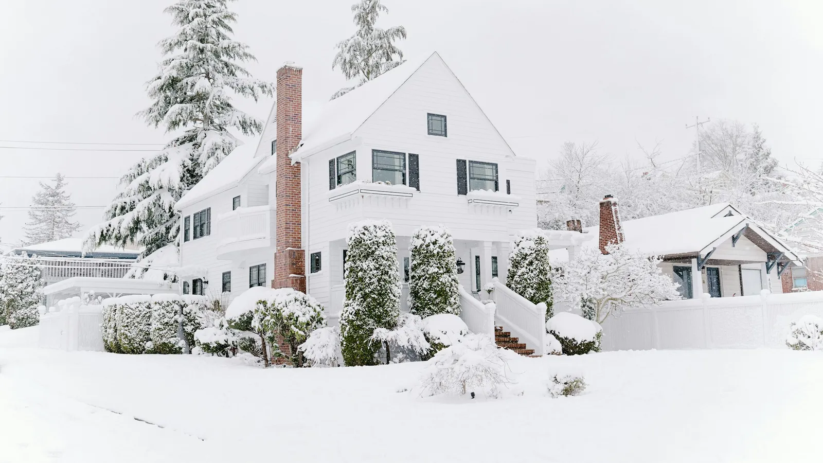 Row of houses under a fresh blanket of snow on a bright winter morning