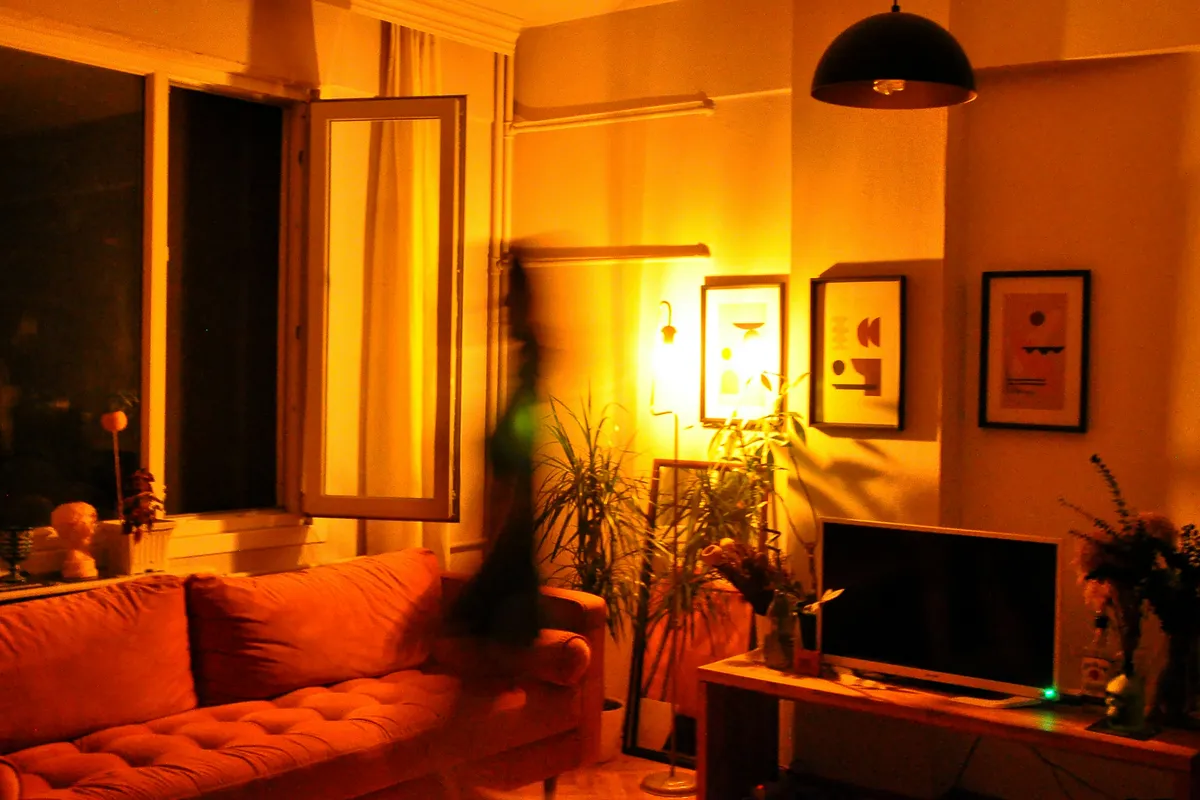 Living room with a flat screen television and warm lamp light