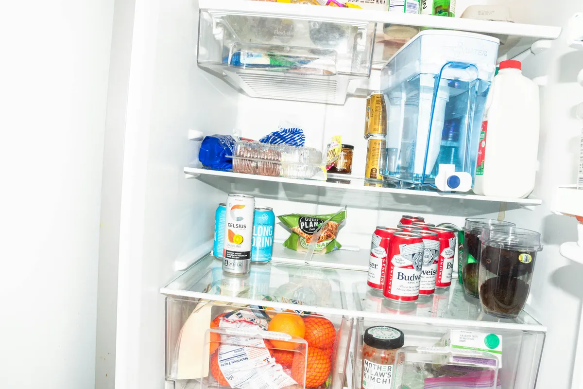 Open refrigerator shelves stocked with food and drinks