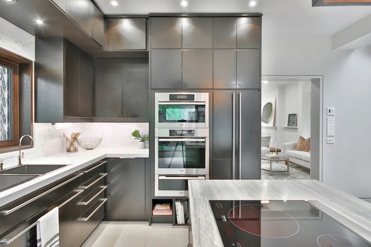 Modern kitchen with stainless steel appliances and marble counters