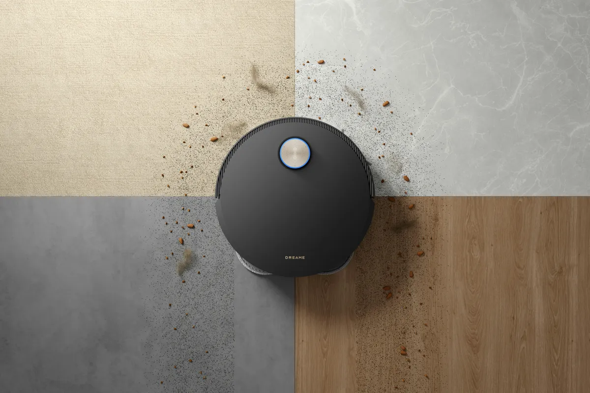 Robot vacuum on a quadrant of four floor types with scattered dirt