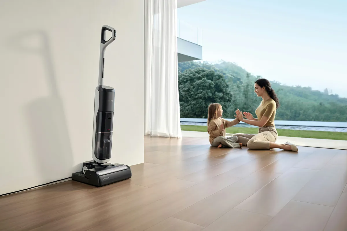 Floor cleaner parked on a wood floor while people sit nearby