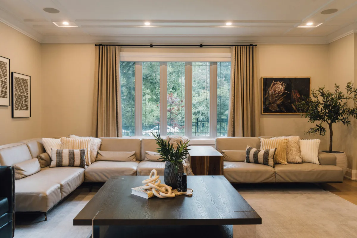 Living room with soft furniture arranged around a large window