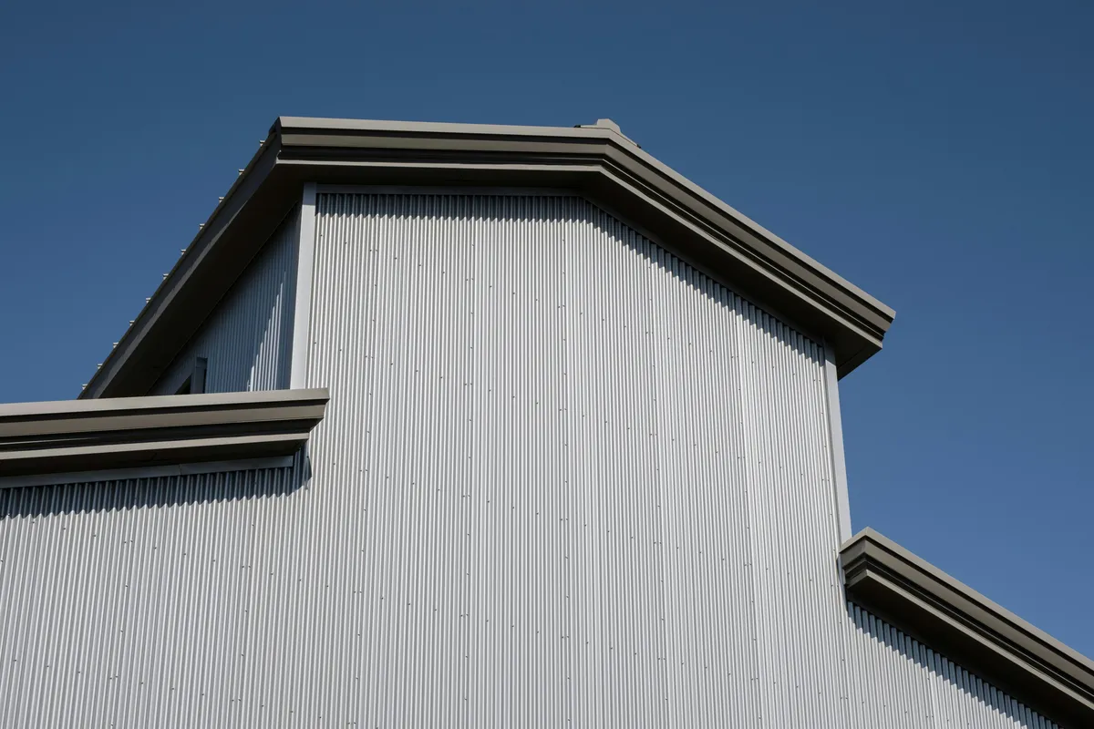 Silver metal clad building standing against open sky