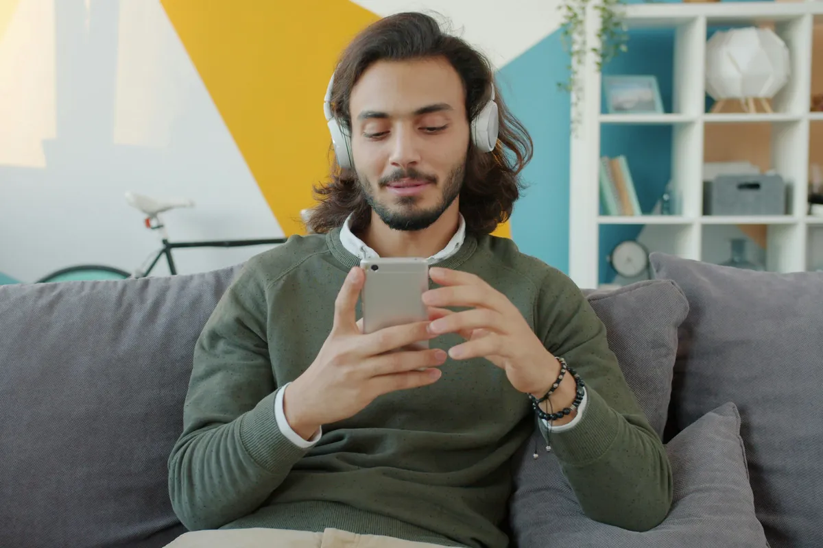Person on a sofa working through an app on a phone