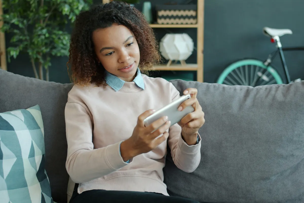 Person tapping through an app on a phone at home