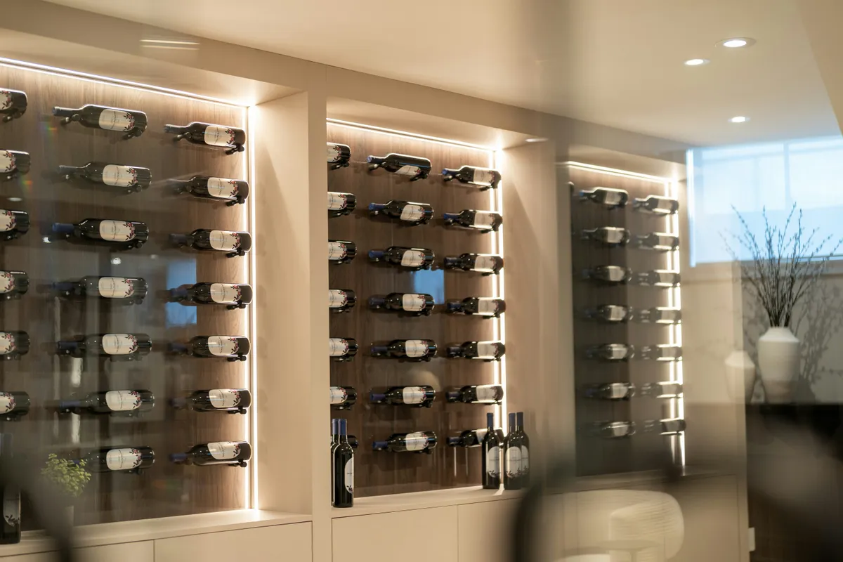Wine cellar wall with illuminated bottle racks