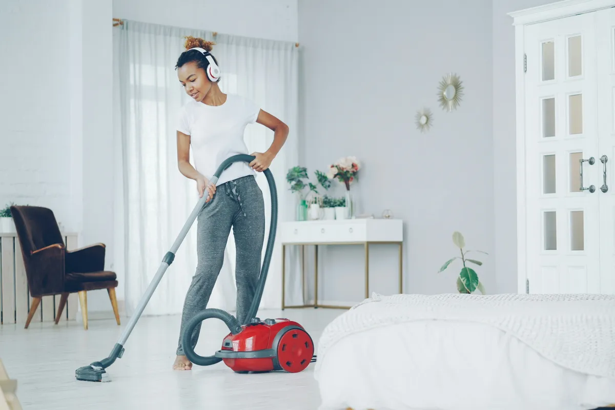 Person running a vacuum across a bright room floor