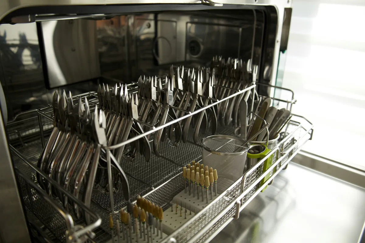 Cutlery standing upright in a dishwasher basket
